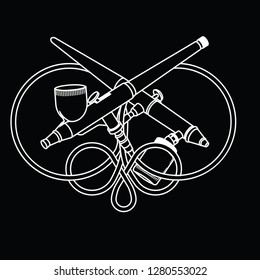 two airbrushes on a black background