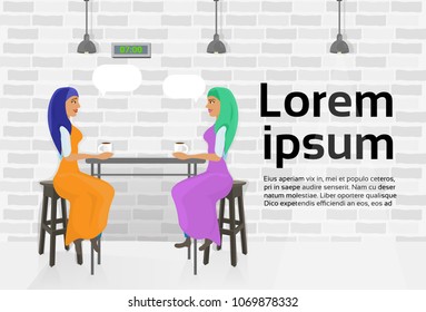 Two Arab Woman Friends Drinking Coffee In Modern Cafe Talking Over Copy Space Background
