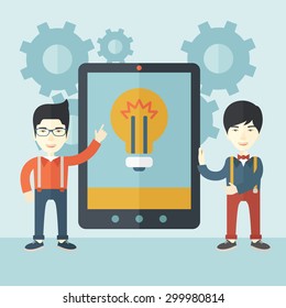 A two asian businessmen standing while holding a big screen tablet with bulb icon a computer tablet perspective view strategy marketing. Business concept. A Contemporary style with pastel palette