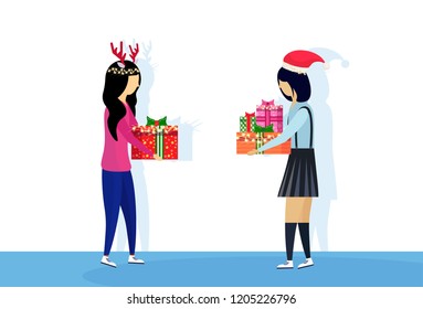 two asian women wearing hat deer horns giving present gift box each other happy new year merry christmas concept female cartoon character profile full length isolated vector illustration