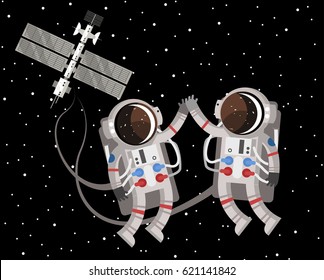 two astronauts floating around space station