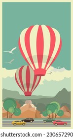 two balloons floating in the sky over the mountain road with cars