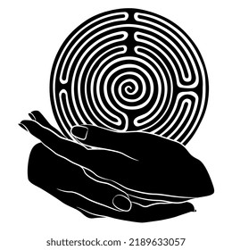 Two beautiful female hands holding a round spiral maze or labyrinth symbol. Ariadne. Creative concept. Black and white silhouette.