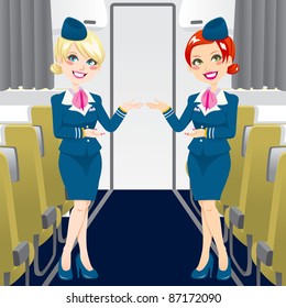 Two beautiful stewardess in blue uniforms inside an airliner passenger cabin