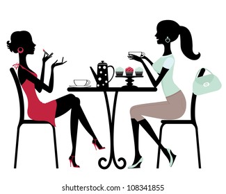 Two beautiful women sitting in a cafe