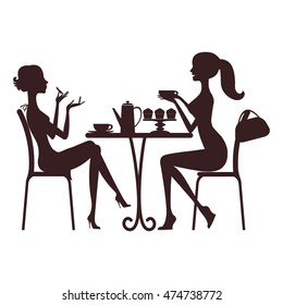 Two beautiful women sitting in a cafe