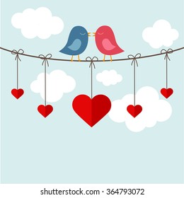 Two birds in love on a cable with hanging hearts