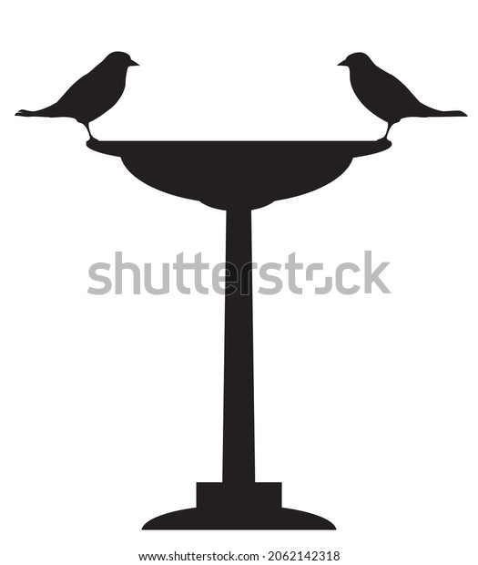 Two birds are standing on a bird bath staring\
at each other in\
silhouette