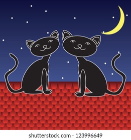 Two black cats sitting on the roof under the Moon