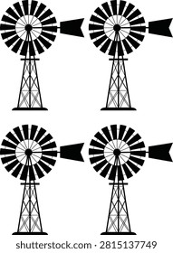 Two black and white windmills standing side by side