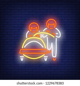 Two bobsledders neon sign. Glowing sportsmen and bob on dark blue brick background. Can be used for sport, winter games, Olympic