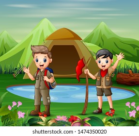Two boys in camping uniform exploring nature