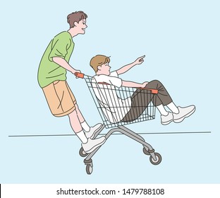 Two boys are enjoying their shopping carts. One boy is sitting in a basket and the other is standing with a handle. hand drawn style vector design illustrations. 