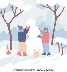 Two boys making a snowman. Children playing outside in winter. Winter activity.