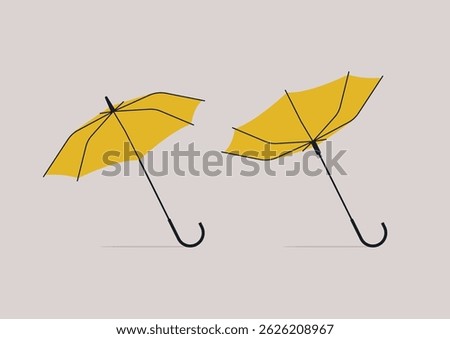 Two bright yellow umbrellas pop against a soft backdrop—one open and steady, the other flipped inside out by a sudden gust, capturing the chaos and charm of city life in the rain