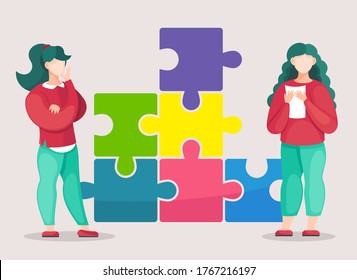 Two brunette girls working at solution of problem. Bussinesswomen working in team, cooperating together, seperated elements of colorful puzzle, making creative collective work, joint business