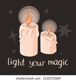 Two burning magic wax candles with quote  on a dark background