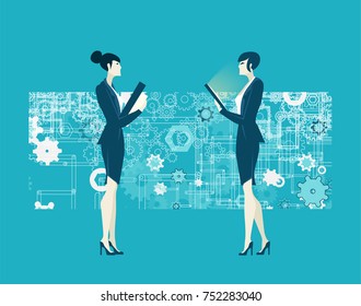 Two business woman talking against of the background made of lots of gears. Human resources concept. 