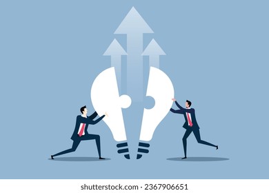 Two businessman completing Idea by combining two puzzles