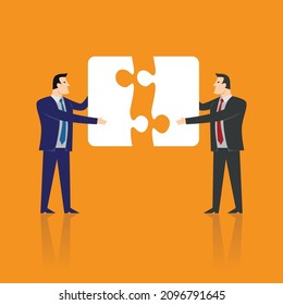 Two businessman completing the jigsaw puzzle