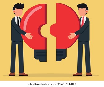 Two businessman putting together light bulb shaped puzzle. Business metaphor of a joint venture, partnership or teamwork