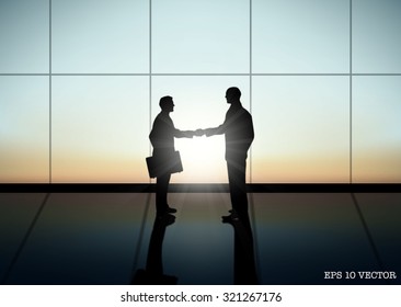 Two Businessman shaking hand silhouettes