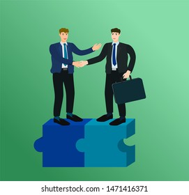 Two businessman standing on complete connect puzzle and handshake for trading agreement