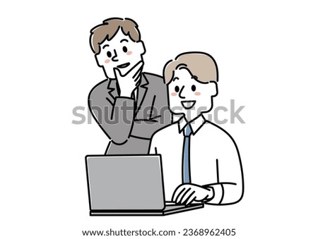 Two businessmen (a man and a man) talking while looking at a computer screen
