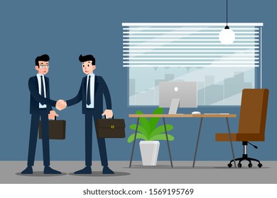Two Businessmen standing and shake hands each other for cooperation and make a deal in the office.