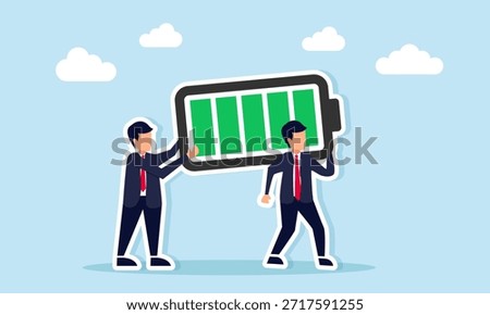 Two businessmen working together to carry a large battery illustrating collaboration in managing powerful business resources