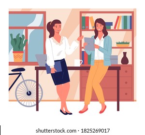 Two businesswomen talking lean at table. Young girl with digital tablet listening colleague with folder. Pretty women discussing work moments. Stylish interior with cabinet, bicycle at background
