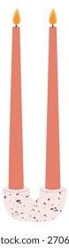 Two candles are lit and are in a vase
