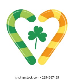 Two candy canes in the form of a heart with a clover leaf. Traditional symbols of Irish holiday. Saint Patricks Day holiday.