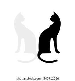 Two cats are black and white. They are looking to each other.