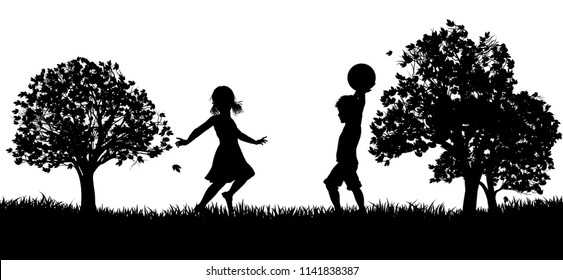 Two children, a boy and a girl, playing in a park or field of grass in silhouette with trees