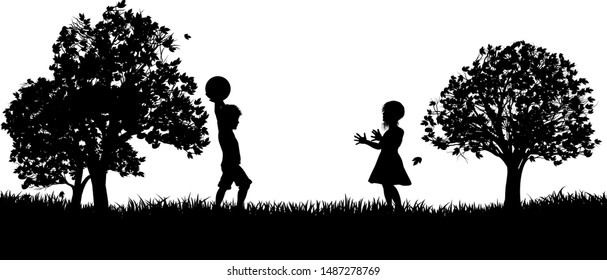 Two children, a boy and a girl, playing throw and catch in a park in silhouette