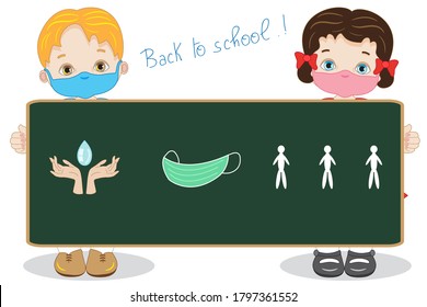 Two children with a large blackboard happily begin the lessons at school with a mask