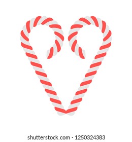 Two Christmas candy sticks in a shape of a heart, isolated on white background. 