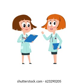 Two comic woman doctor characters, one telling, another writing something into medical record, cartoon vector illustration isolated on white background. Funny woman doctors filling in medical cards