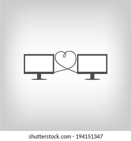 Two computers connected with wires in heart shape. Virtual love