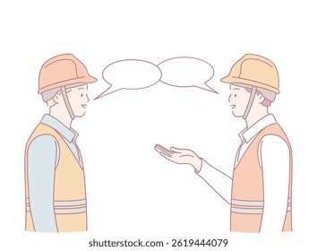Two construction workers in helmets and vests discuss important details about their current project