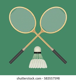 Two crossed badminton rackets and white shuttlecock with black line. Vector illustration of equipments for badminton game sport isolated on green background in flat design. Rackets and shuttlecock