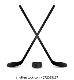 Two crossed hockey sticks and hockey puck. Isolated on white background. Vector EPS10 illustration. 