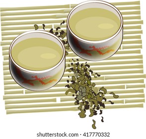 Two cups of green tea with the particles of tea on bamboo mat