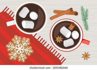 Two cups of hot drink on wooden table with red napkin with snowflake gingerbread cookie, spices. Hot Chocolate or coffee with marshmallow, cinnamon and anise. Merry Christmas or new year background.