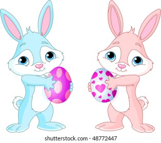 Two Cute Easter Bunnies  holding Easter Eggs