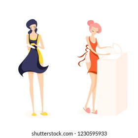 Two cute girl cleaners. Girl with pink hair is washing a plate and brunette is washing dishes. They are work a orange, yellow and blue aprons. Isolated flat illustration