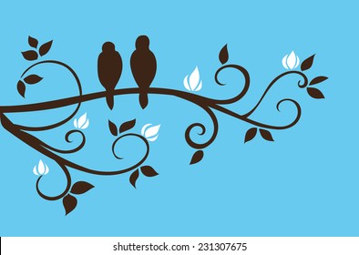 Two cute little birds sitting on a twisted branch with white flowers