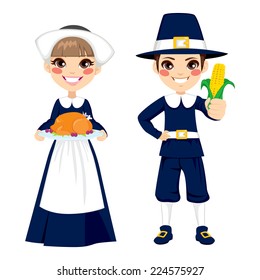 Two cute little children in pilgrim costume holding turkey and corn to celebrate Thanksgiving day