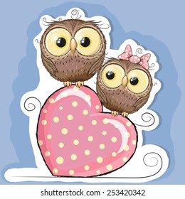 Two Cute Owls is sitting on a heart 